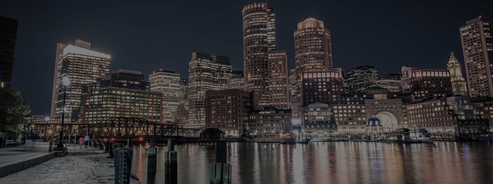 Decorative photo of Boston Harbor and Boston skyline at night